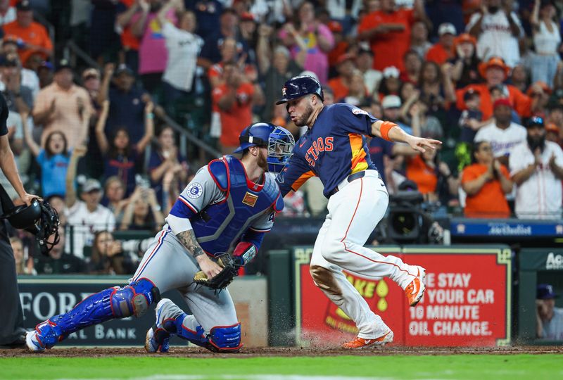 Apr 14, 2024; Houston, Texas, USA; Houston Astros catcher Victor Caratini (17) scores a run past Texas Rangers catcher Jonah Heim (28) during the fourth inning at Minute Maid Park. Mandatory Credit: Troy Taormina-USA TODAY Sports