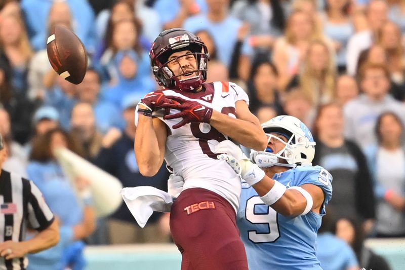 Oct 1, 2022; Chapel Hill, North Carolina, USA; North Carolina Tar Heels defensive back Cam'Ron Kelly (9) breaks up a pass intended for Virginia Tech Hokies wide receiver Kaleb Smith (80) in the fourth quarter at Kenan Memorial Stadium. Mandatory Credit: Bob Donnan-USA TODAY Sports