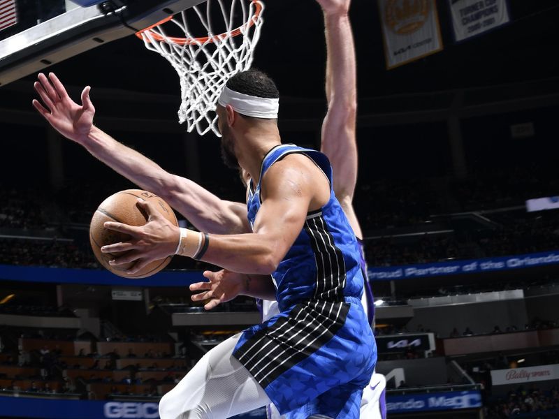 ORLANDO, FL - MARCH 23: Jalen Suggs #4 of the Orlando Magic saves the ball from going out of bounds during the game against the Sacramento Kings on March 23, 2024 at the Kia Center in Orlando, Florida. NOTE TO USER: User expressly acknowledges and agrees that, by downloading and or using this photograph, User is consenting to the terms and conditions of the Getty Images License Agreement. Mandatory Copyright Notice: Copyright 2024 NBAE (Photo by Fernando Medina/NBAE via Getty Images)