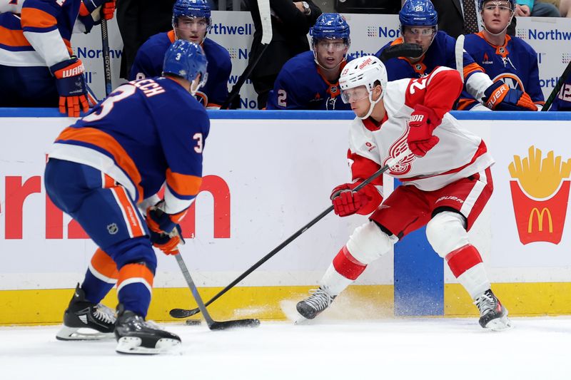 Oct 22, 2024; Elmont, New York, USA; Detroit Red Wings left wing Lucas Raymond (23) fights for the puck against New York Islanders defenseman Adam Pelech (3) during the third period at UBS Arena. Mandatory Credit: Brad Penner-Imagn Images