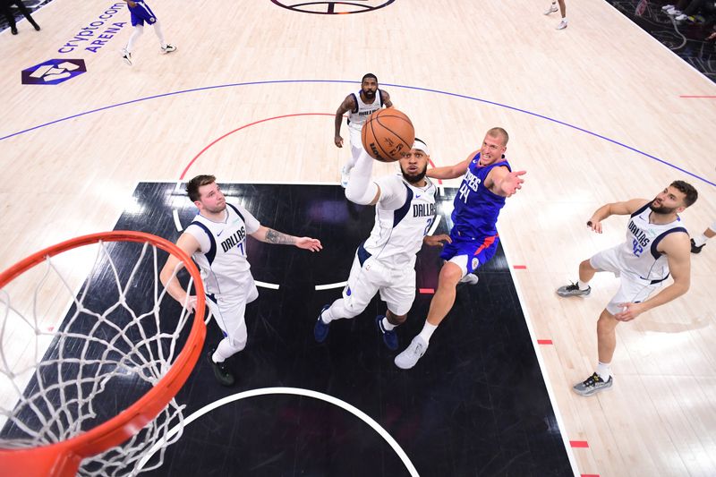 LOS ANGELES, CA - APRIL 21:  Daniel Gafford #21 of the Dallas Mavericks grabs a rebound during the game against the LA Clippers during Round 1 Game 1 of the 2024 NBA Playoffs on April 21, 2024 at Crypto.Com Arena in Los Angeles, California. NOTE TO USER: User expressly acknowledges and agrees that, by downloading and/or using this Photograph, user is consenting to the terms and conditions of the Getty Images License Agreement. Mandatory Copyright Notice: Copyright 2024 NBAE (Photo by Adam Pantozzi/NBAE via Getty Images)