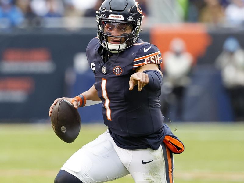 Chicago Bears quarterback Justin Fields (1) runs with the ball to score a touchdown against the Detroit Lions during the second half of an NFL football game, Sunday, Dec. 10, 2023, in Chicago. (AP Photo/Kamil Krzaczynski)