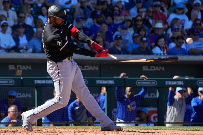 Mar 1, 2024; Mesa, Arizona, USA; Chicago White Sox designated hitter Eloy Jimenez (74) hits a single against the Chicago Cubs in the fourth inning at Sloan Park. Mandatory Credit: Rick Scuteri-USA TODAY Sports