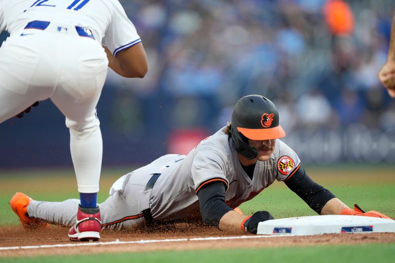 Jun 4, 2024; Toronto, Ontario, CAN; Baltimore Orioles shortstop Gunnar Henderson (2) slides into third base on a hit by designated hitter Adley Rutschman (not pictured) against the the Toronto Blue Jays during the third inning at Rogers Centre. Mandatory Credit: John E. Sokolowski-USA TODAY Sports