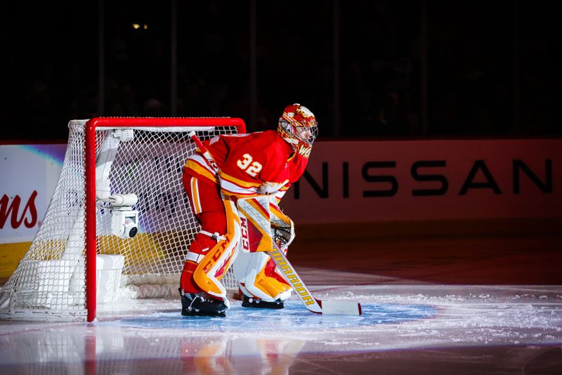 Apr 12, 2023; Calgary, Alberta, CAN; Calgary Flames goaltender Dustin Wolf (32) in his net prior to the game against the San Jose Sharks at Scotiabank Saddledome. Mandatory Credit: Sergei Belski-USA TODAY Sports