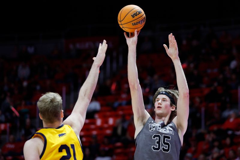 Feb 5, 2023; Salt Lake City, Utah, USA; Utah Utes center Branden Carlson (35) shoots over California Golden Bears forward Lars Thiemann (21) in the second half at Jon M. Huntsman Center. Mandatory Credit: Jeffrey Swinger-USA TODAY Sports