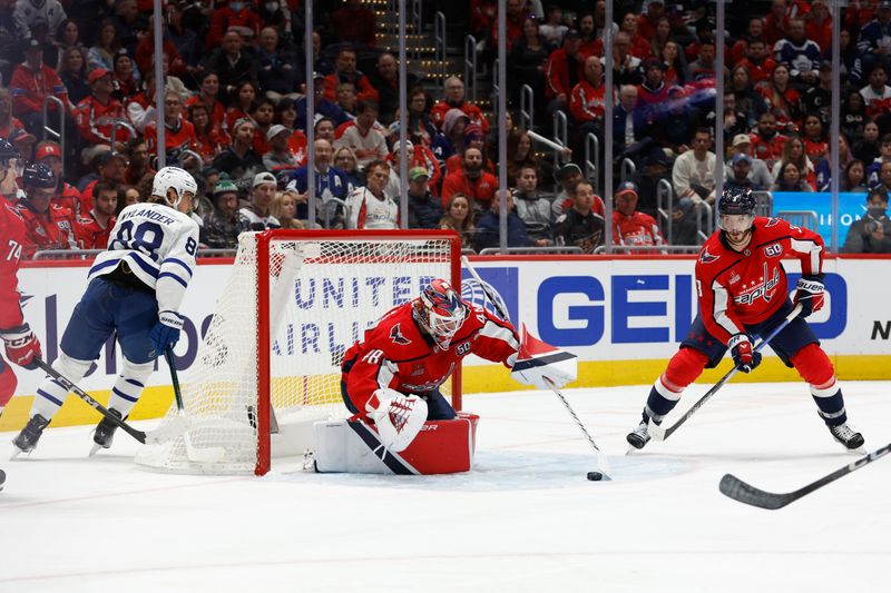 Nov 13, 2024; Washington, District of Columbia, USA; Washington Capitals goaltender Logan Thompson (48) covers the puck as Toronto Maple Leafs right wing William Nylander (88) and Capitals defenseman Matt Roy (3) look on in the second period at Capital One Arena. Mandatory Credit: Geoff Burke-Imagn Images