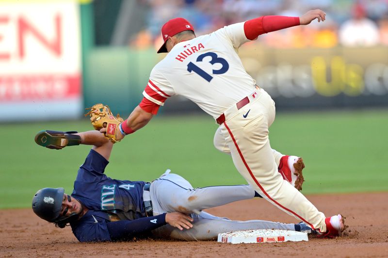 Jul 13, 2024; Anaheim, California, USA;  Josh Rojas #4 of the Seattle Mariners is caught stealing on tag by Keston Hiura #13 of the Los Angeles Angels in the second inning at Angel Stadium. Mandatory Credit: Jayne Kamin-Oncea-USA TODAY Sports