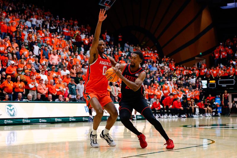 Feb 21, 2026; Fort Collins, Colorado, USA; San Diego State Aztecs forward Jeremiah Oden (25) controls the ball as Colorado State Rams forward Carey Booth (0) guards in the first half at Moby Arena. Mandatory Credit: Isaiah J. Downing-Imagn Images
