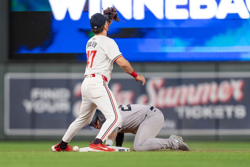 May 15, 2024; Minneapolis, Minnesota, USA; New York Yankees second base Gleyber Torres (25) steals after Minnesota Twins second base Edouard Julien (47) bobbled the throw in the eighth inning at Target Field. Mandatory Credit: Matt Blewett-USA TODAY Sports