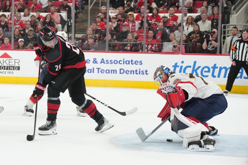 May 20, 2025; Raleigh, North Carolina, USA; Florida Panthers goaltender Sergei Bobrovsky (72) blocks a shot as Carolina Hurricanes forward Sebastian Aho (20) looks on during the first period in game one of the Eastern Conference Final of the 2025 Stanley Cup Playoffs at Lenovo Center. Mandatory Credit: James Guillory-Imagn Images