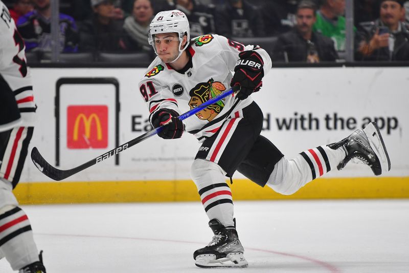 Apr 18, 2024; Los Angeles, California, USA; Chicago Blackhawks center Frank Nazar (91) shoots on goal against the Los Angeles Kings during the first period at Crypto.com Arena. Mandatory Credit: Gary A. Vasquez-USA TODAY Sports