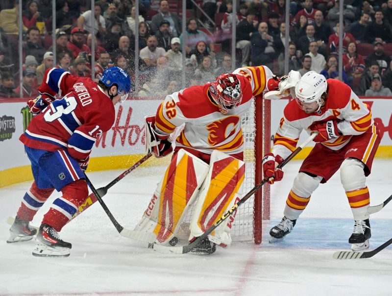 Nov 5, 2024; Montreal, Quebec, CAN; Calgary Flames goalie Dustin Wolf (32) loses the puck in his skates and Montreal Canadiens forward Cole Caufield (13) attempts to dig it out during the second period at the Bell Centre. Mandatory Credit: Eric Bolte-Imagn Images