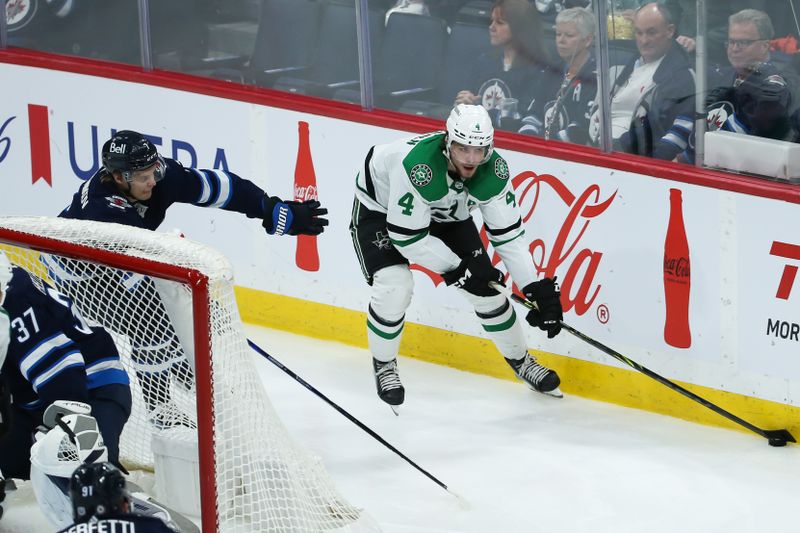 Nov 11, 2023; Winnipeg, Manitoba, CAN;  Dallas Stars defenseman Miro Heiskanen (4) skates away from Winnipeg Jets forward Vladislav Namestnikov (7) during the third period at Canada Life Centre. Mandatory Credit: Terrence Lee-USA TODAY Sports