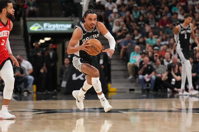 SAN ANTONIO, TX - MARCH 12: Tre Jones #33 of the San Antonio Spurs dribbles the ball during the game against the Houston Rockets on March 12, 2024 at the Frost Bank Center in San Antonio, Texas. NOTE TO USER: User expressly acknowledges and agrees that, by downloading and or using this photograph, user is consenting to the terms and conditions of the Getty Images License Agreement. Mandatory Copyright Notice: Copyright 2024 NBAE (Photos by Jesse D. Garrabrant/NBAE via Getty Images)