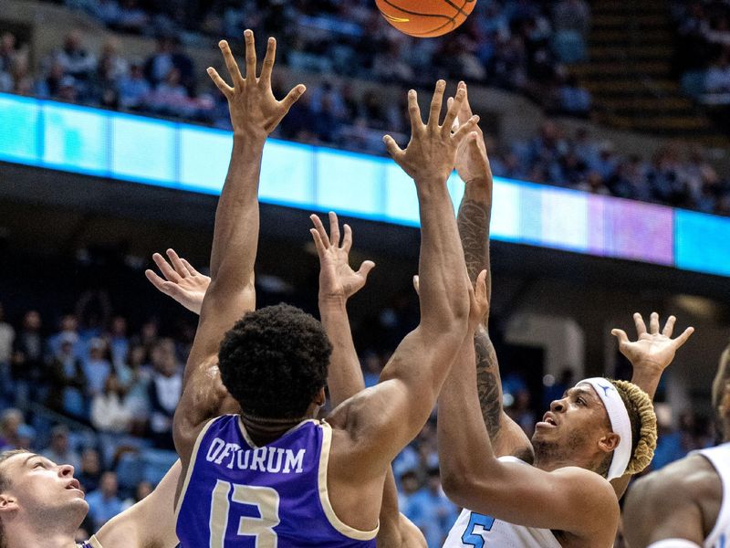 Nov 20, 2022; Chapel Hill, North Carolina, USA; North Carolina Tar Heels forward Armando Bacot (5) shoots as James Madison Dukes guard Noah Freidel (1) and forward Mezie Offurum (13) defend in the second half at Dean E. Smith Center. Mandatory Credit: Bob Donnan-USA TODAY Sports