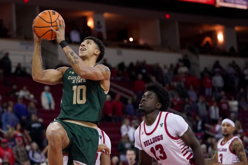 Feb 3, 2024; Fresno, California, USA; Colorado State Rams guard Nique Clifford (10) makes a basket in front of Fresno State Bulldogs center Enoch Boakye (13) in the first half at the Save Mart Center. Mandatory Credit: Cary Edmondson-USA TODAY Sports