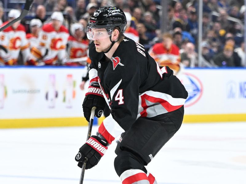 Nov 19, 2025; Buffalo, New York, USA; Buffalo Sabres defenseman Bowen Byram (4) handles the puck against the Calgary Flames in the second period at KeyBank Center. Mandatory Credit: Mark Konezny-Imagn Images
