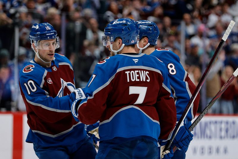 Apr 10, 2025; Denver, Colorado, USA; Colorado Avalanche defenseman Devon Toews (7) celebrates his goal with center Charlie Coyle (10) and defenseman Cale Makar (8) in the second period against the Vancouver Canucks at Ball Arena. Mandatory Credit: Isaiah J. Downing-Imagn Images