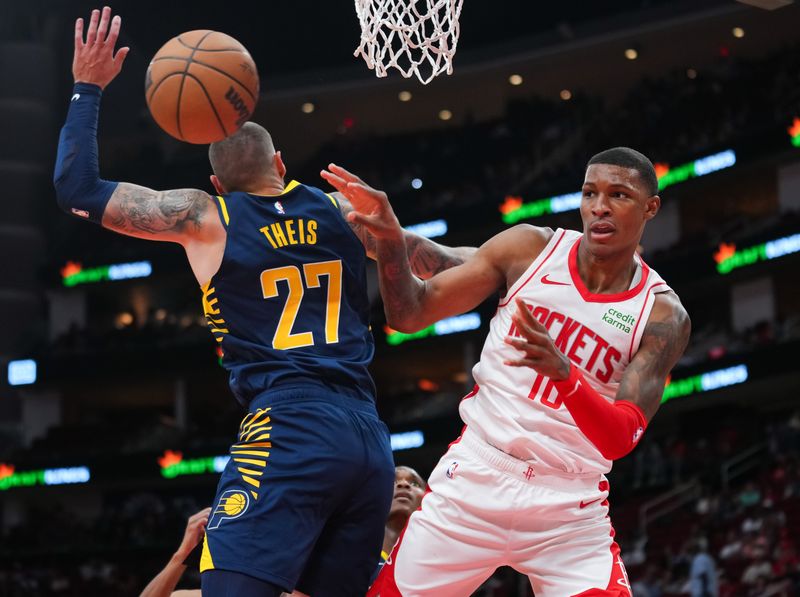 HOUSTON, TEXAS - OCTOBER 10: Jabari Smith Jr. #10 of the Houston Rockets passes the ball around Daniel Theis #27 of the Indiana Pacers during the third quarter of the preseason game at Toyota Center on October 10, 2023 in Houston, Texas. NOTE TO USER: User expressly acknowledges and agrees that, by downloading and or using this photograph, User is consenting to the terms and conditions of the Getty Images License Agreement. (Photo by Alex Bierens de Haan/Getty Images)