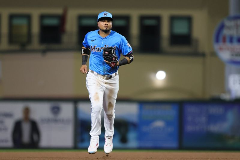 Mar 8, 2024; Jupiter, Florida, USA; Miami Marlins second baseman Luis Arraez (3) runs on the field against the New York Mets after the fourth inning at Roger Dean Chevrolet Stadium. Mandatory Credit: Sam Navarro-USA TODAY Sports