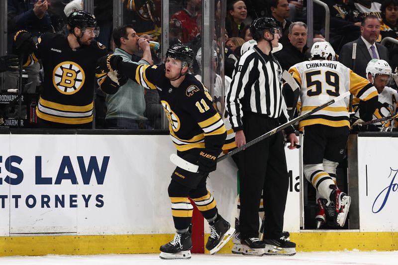 Mar 3, 2026; Boston, Massachusetts, USA; As Pittsburgh Penguins right wing Egor Chinakhov (59) heads to the bench, Boston Bruins center Casey Mittelstadt (11) is congratulated at the bench after scoring during the first period at TD Garden. Mandatory Credit: Winslow Townson-Imagn Images