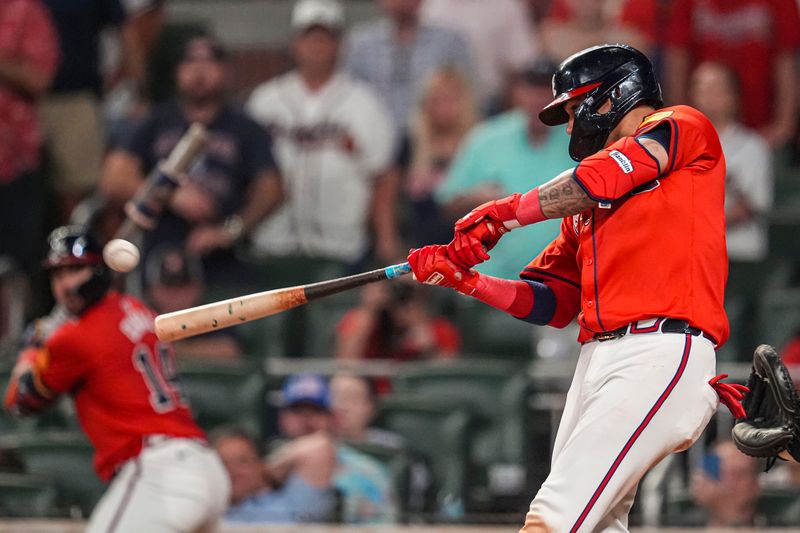 Aug 2, 2024; Cumberland, Georgia, USA; Atlanta Braves shortstop Orlando Arcia (11) hits a single to drive in a run against the Miami Marlins during the eighth inning at Truist Park. Mandatory Credit: Dale Zanine-USA TODAY Sports