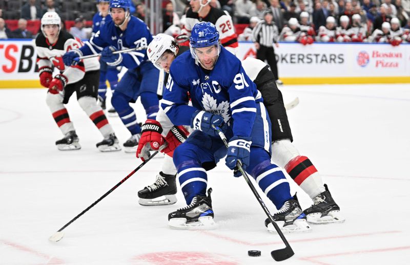 Apr 11, 2024; Toronto, Ontario, CAN; Toronto Maple Leafs forward John Tavares (91) carries the puck past New Jersey Devils defenseman John Marino (6) in the first period at Scotiabank Arena. Mandatory Credit: Dan Hamilton-USA TODAY Sports