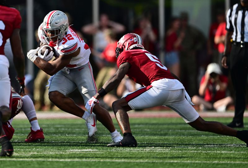 Sep 2, 2023; Bloomington, Indiana, USA; Ohio State Buckeyes running back TreVeyon Henderson (32) runs by  Indiana Hoosiers defensive back Kobee Minor (5) during the second half at Memorial Stadium. Mandatory Credit: Marc Lebryk-USA TODAY Sports