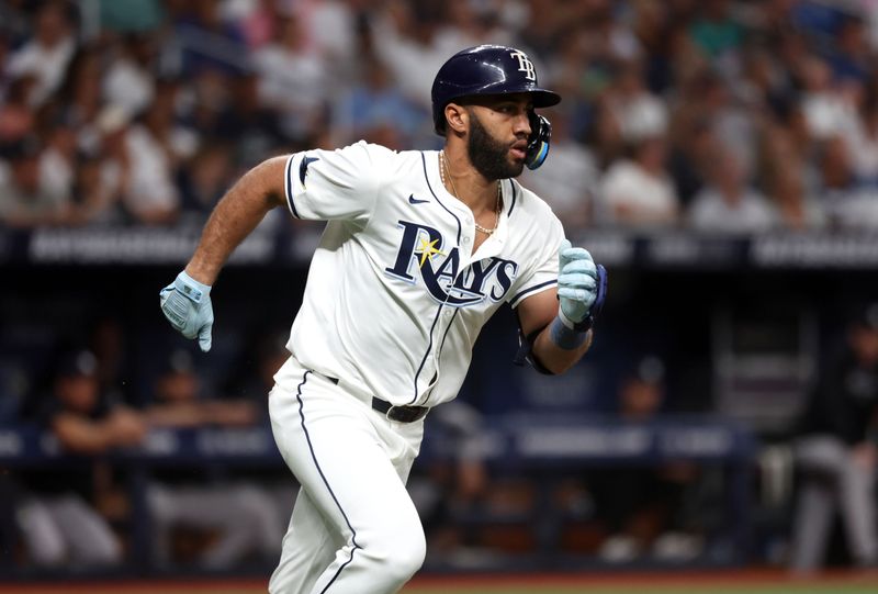 Jul 9, 2024; St. Petersburg, Florida, USA;  Tampa Bay Rays outfielder Amed Rosario (10) singles against the New York Yankees during the first inning at Tropicana Field. Mandatory Credit: Kim Klement Neitzel-USA TODAY Sports