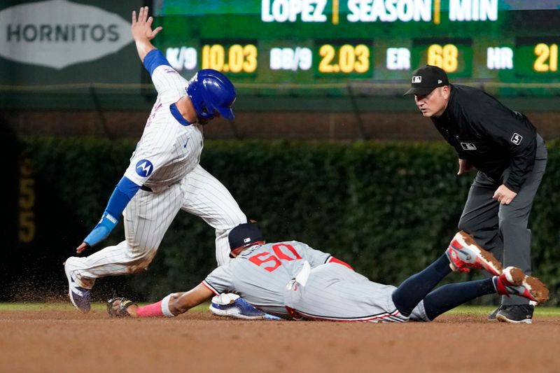 Aug 6, 2024; Chicago, Illinois, USA; Chicago Cubs first baseman Michael Busch (29) is safe at second base as Minnesota Twins shortstop Willi Castro (50) makes a late tag during the fifth inning at Wrigley Field. Mandatory Credit: David Banks-USA TODAY Sports