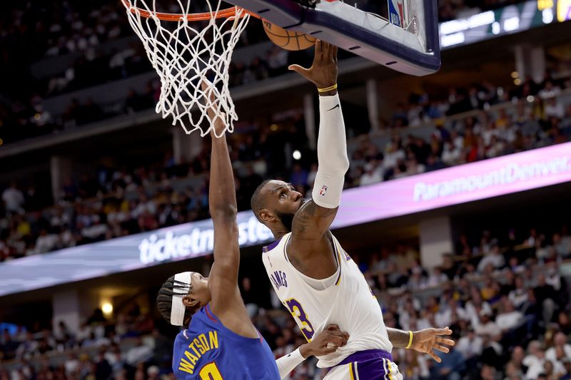 DENVER, COLORADO - APRIL 20: LeBron James #23 of the Los Angeles Lakers goes to the basket against Peyton Watson #8 of the Denver Nuggets in the first quarter during game one of the Western Conference First Round Playoffs at Ball Arena on April 20, 2024 in Denver, Colorado.  NOTE TO USER: User expressly acknowledges and agrees that, by downloading and or using this photograph, User is consenting to the terms and conditions of the Getty Images License Agreement. (Photo by Matthew Stockman/Getty Images)