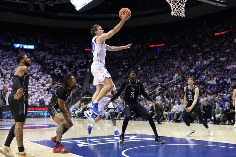 Feb 13, 2024; Provo, Utah, USA; Brigham Young Cougars guard Dallin Hall (30) lays the ball up against the Central Florida Knights during the second half at Marriott Center. Mandatory Credit: Rob Gray-USA TODAY Sports