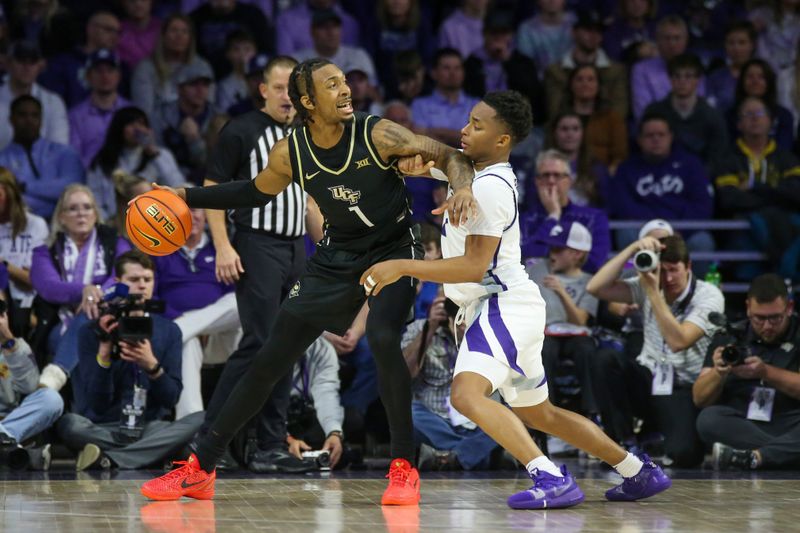 Jan 6, 2024; Manhattan, Kansas, USA; UCF Knights guard Antwann Jones (1) is guarded by Kansas State Wildcats guard Tylor Perry (2) during the first half at Bramlage Coliseum. Mandatory Credit: Scott Sewell-USA TODAY Sports