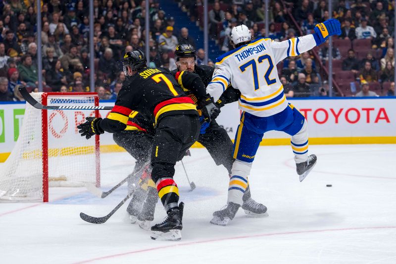 Jan 21, 2025; Vancouver, British Columbia, CAN; Vancouver Canucks defenseman Carson Soucy (7) and Vancouver Canucks defenseman Vincent Desharnais (73) battles with Buffalo Sabres forward Tage Thompson (72) in the first period at Rogers Arena. Mandatory Credit: Bob Frid-Imagn Images