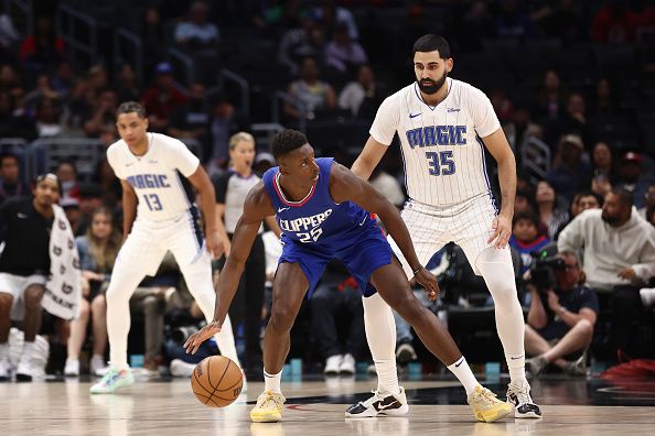 LOS ANGELES, CALIFORNIA - OCTOBER 31: Moussa Diabate #25 of the Los Angeles Clippers dribbles the ball against Goga Bitadze #35 of the Orlando Magic during the fourth quarter at Crypto.com Arena on October 31, 2023 in Los Angeles, California. NOTE TO USER: User expressly acknowledges and agrees that, by downloading and or using this photograph, User is consenting to the terms and conditions of the Getty Images License Agreement. (Photo by Katelyn Mulcahy/Getty Images)