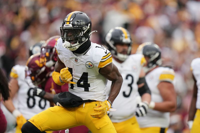 Pittsburgh Steelers wide receiver George Pickens (14) reacts after a first down during the second half of an NFL football game against the Washington Commanders, Sunday, Nov. 10, 2024, in Landover, Md. (AP Photo/Stephanie Scarbrough)