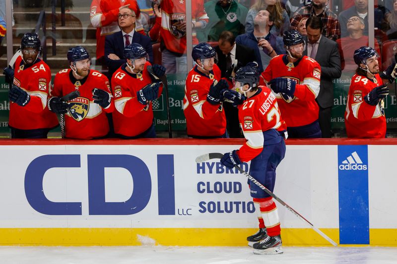 Feb 6, 2023; Sunrise, Florida, USA; Florida Panthers center Eetu Luostarinen (27) celebrates with teammates after scoring during the second period against the Tampa Bay Lightning at FLA Live Arena. Mandatory Credit: Sam Navarro-USA TODAY Sports