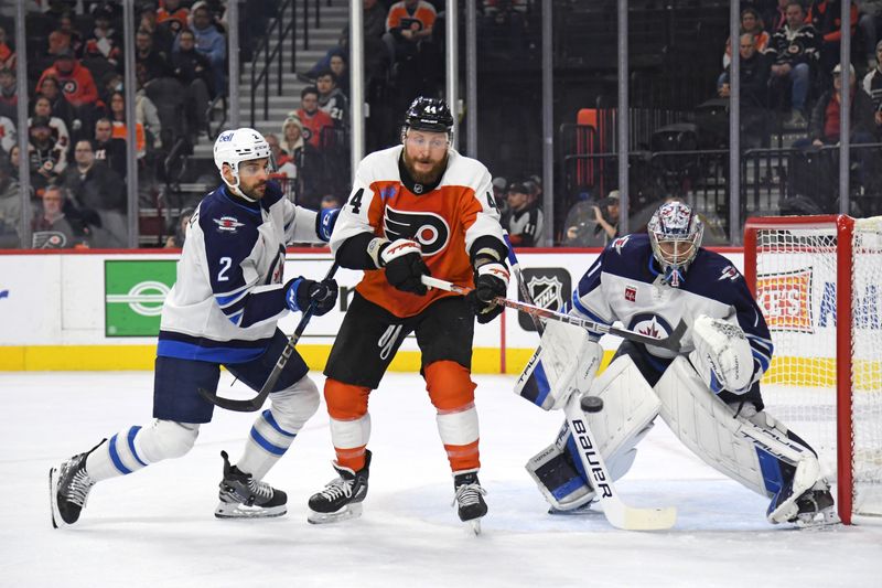 Mar 6, 2025; Philadelphia, Pennsylvania, USA; Philadelphia Flyers left wing Nicolas Deslauriers (44) tries to deflect the puck against defenseman Dylan DeMelo (2) and Winnipeg Jets goaltender Eric Comrie (1) during the first period at Wells Fargo Center. Mandatory Credit: Eric Hartline-Imagn Images