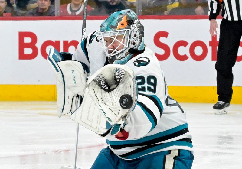 Jan 11, 2024; Montreal, Quebec, CAN; San Jose Sharks goalie Mackenzie Blackwood (29) makes a glove save during the third period of the game against the Montreal Canadiens at the Bell Centre. Mandatory Credit: Eric Bolte-USA TODAY Sports