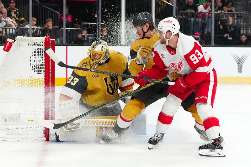 Mar 22, 2025; Las Vegas, Nevada, USA; Vegas Golden Knights goaltender Adin Hill (33) watches the puck after making a save against Detroit Red Wings right wing Alex DeBrincat (93) as Vegas Golden Knights defenseman Kaedan Korczak (6) looks to avoid colliding with his goaltender during the second period at T-Mobile Arena. Mandatory Credit: Stephen R. Sylvanie-Imagn Images