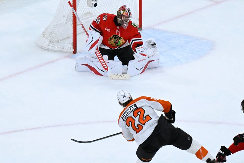 Dec 23, 2025; Chicago, Illinois, USA;  Chicago Blackhawks goaltender Spencer Knight (30) defends against Philadelphia Flyers center Christian Dvorak (22) during the second period at United Center. Mandatory Credit: Matt Marton-Imagn Images