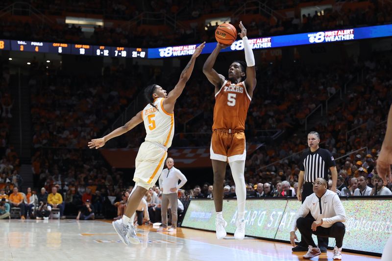 Jan 28, 2023; Knoxville, Tennessee, USA; Texas Longhorns guard Marcus Carr (5) shoots the ball against Tennessee Volunteers guard Zakai Zeigler (5) during the second half at Thompson-Boling Arena. Mandatory Credit: Randy Sartin-USA TODAY Sports