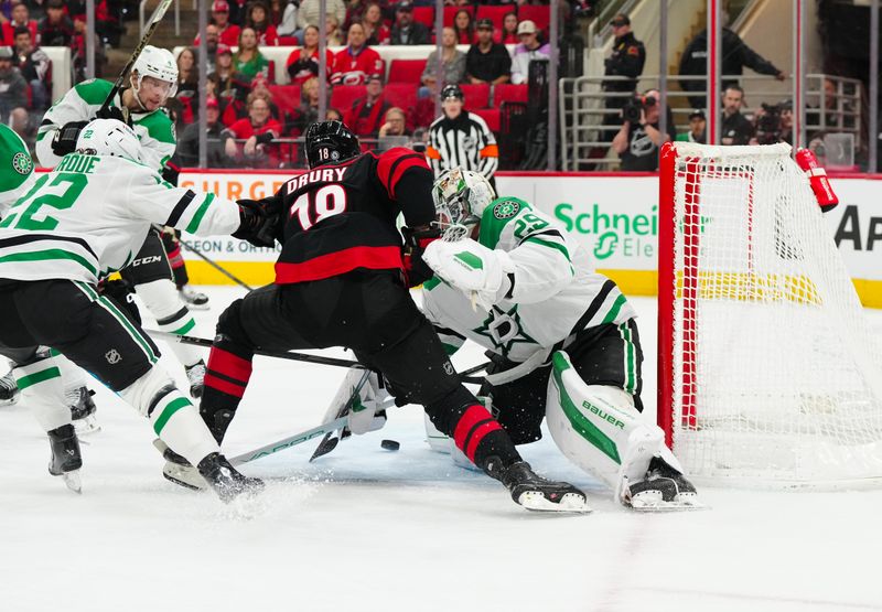 Nov 25, 2024; Raleigh, North Carolina, USA;  Dallas Stars goaltender Jake Oettinger (29) stops the scoring attempt by Carolina Hurricanes center Jack Drury (18) during the first period at Lenovo Center. Mandatory Credit: James Guillory-Imagn Images