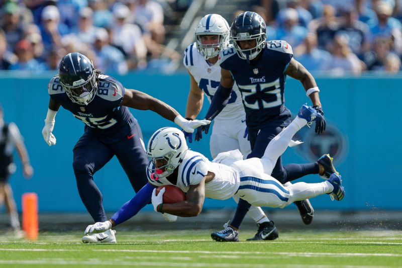 Indianapolis Colts wide receiver Josh Downs (1) returns a kick off as Tennessee Titans tight end Chig Okonkwo (85) defends during the first half of an NFL football game, Sunday, Oct. 13, 2024, in Nashville, Tenn. (AP Photo/Stew Milne)