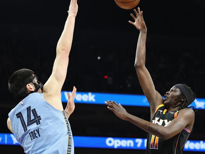 PHOENIX, ARIZONA - FEBRUARY 11: Bol Bol #11 of the Phoenix Suns puts up a over Zach Edey #14 of the Memphis Grizzlies during the first half of the NBA game at Footprint Center on February 11, 2025 in Phoenix, Arizona.  NOTE TO USER: User expressly acknowledges and agrees that, by downloading and or using this photograph, User is consenting to the terms and conditions of the Getty Images License Agreement.  (Photo by Christian Petersen/Getty Images)