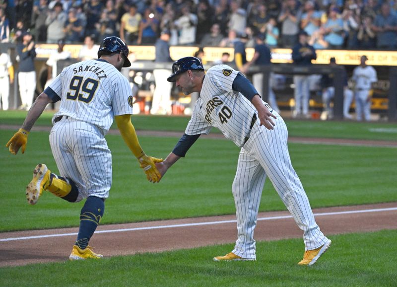 Sep 7, 2024; Milwaukee, Wisconsin, USA; Milwaukee Brewers catcher Gary Sánchez (99) is congratulated by Milwaukee Brewers third base coach Jason Lane (40) as he rounds the bases after hitting a home run against the Colorado Rockies in the first inning at American Family Field. Mandatory Credit: Michael McLoone-Imagn Images