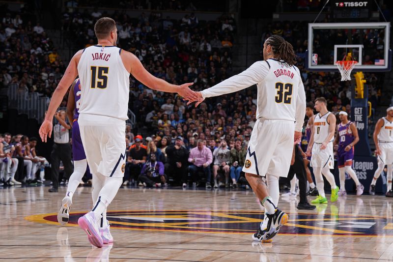 DENVER, CO - OCTOBER 13: Nikola Jokic #15 and Aaron Gordon #32 of the Denver Nuggets high five during the game against the Phoenix Suns on October 13, 2024 at Ball Arena in Denver, Colorado. NOTE TO USER: User expressly acknowledges and agrees that, by downloading and/or using this Photograph, user is consenting to the terms and conditions of the Getty Images License Agreement. Mandatory Copyright Notice: Copyright 2024 NBAE (Photo by Garrett Ellwood/NBAE via Getty Images)