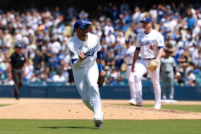 May 8, 2024; Los Angeles, California, USA;  Los Angeles Dodgers second baseman Miguel Rojas (11) celebrates a victory after defeating the Miami Marlins at Dodger Stadium. Mandatory Credit: Kiyoshi Mio-USA TODAY Sports