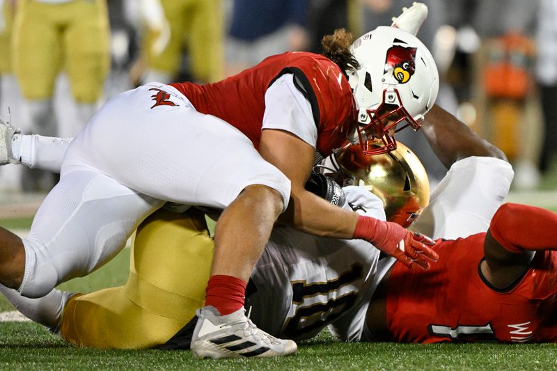 Oct 7, 2023; Louisville, Kentucky, USA; Louisville Cardinals defensive lineman Ashton Gillotte (9) sacks Notre Dame Fighting Irish quarterback Sam Hartman (10) during the second half at L&N Federal Credit Union Stadium. Louisville defeated Notre Dame 33-20. Mandatory Credit: Jamie Rhodes-USA TODAY Sports